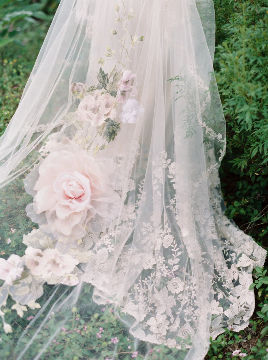 Floral lace wedding veil detail in garden setting