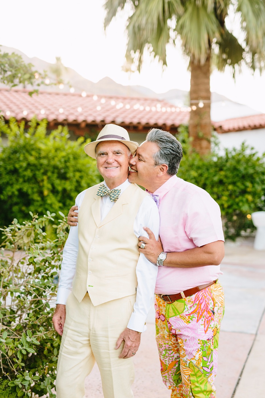 Gay couple celebrating at outdoor wedding event