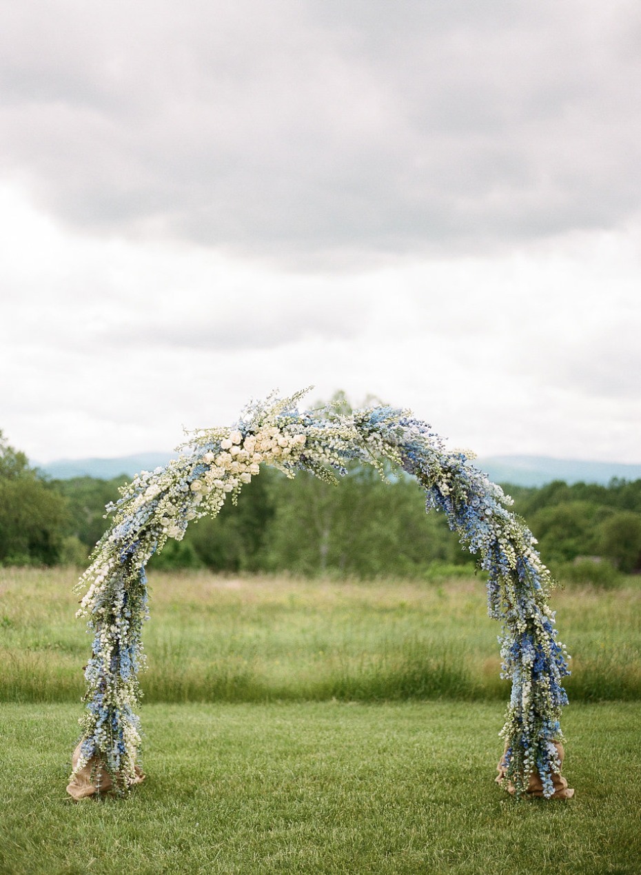 Floral arch for outdoor wedding ceremony in a field