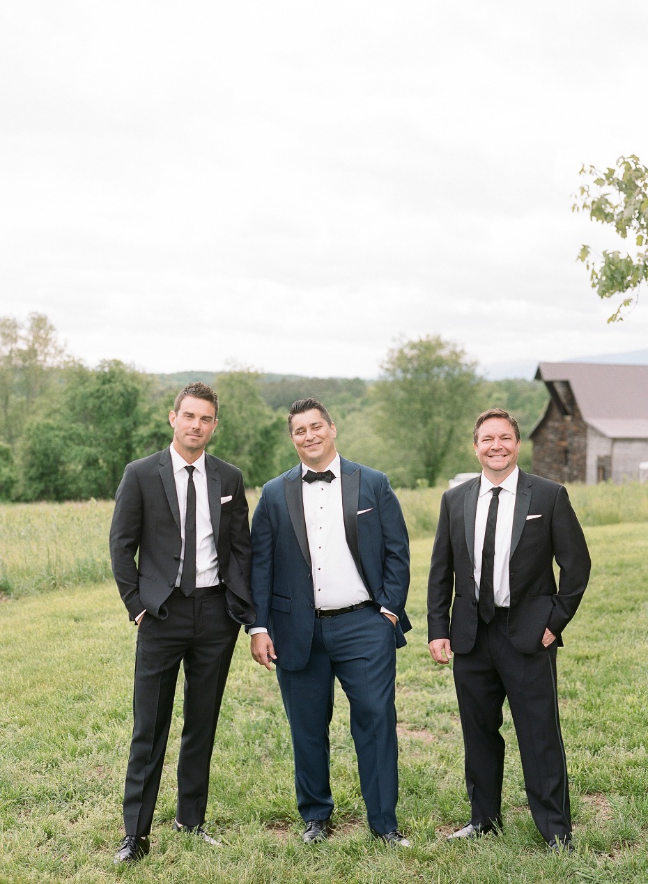 groom in navy and groomsmen in classic blac