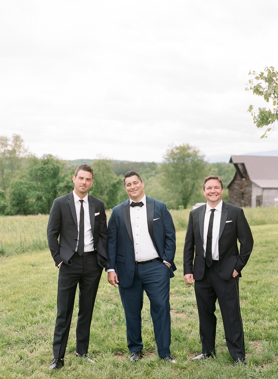 Groom and groomsmen in suits outdoor wedding party