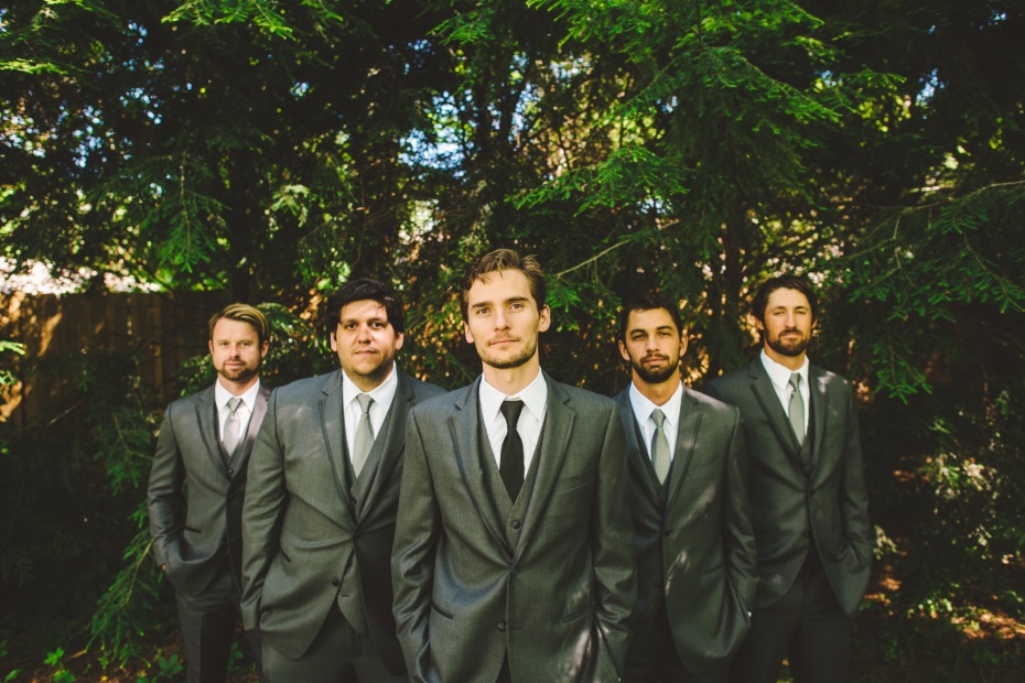 groom in charcoal grey suit and groomsmen in matching suits