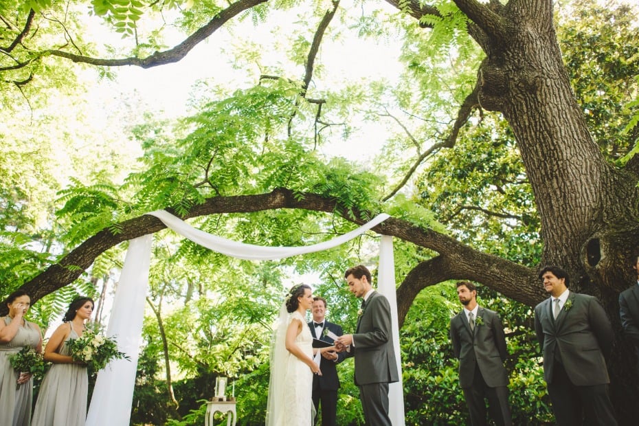 garden wedding ceremony with simple white sash decor