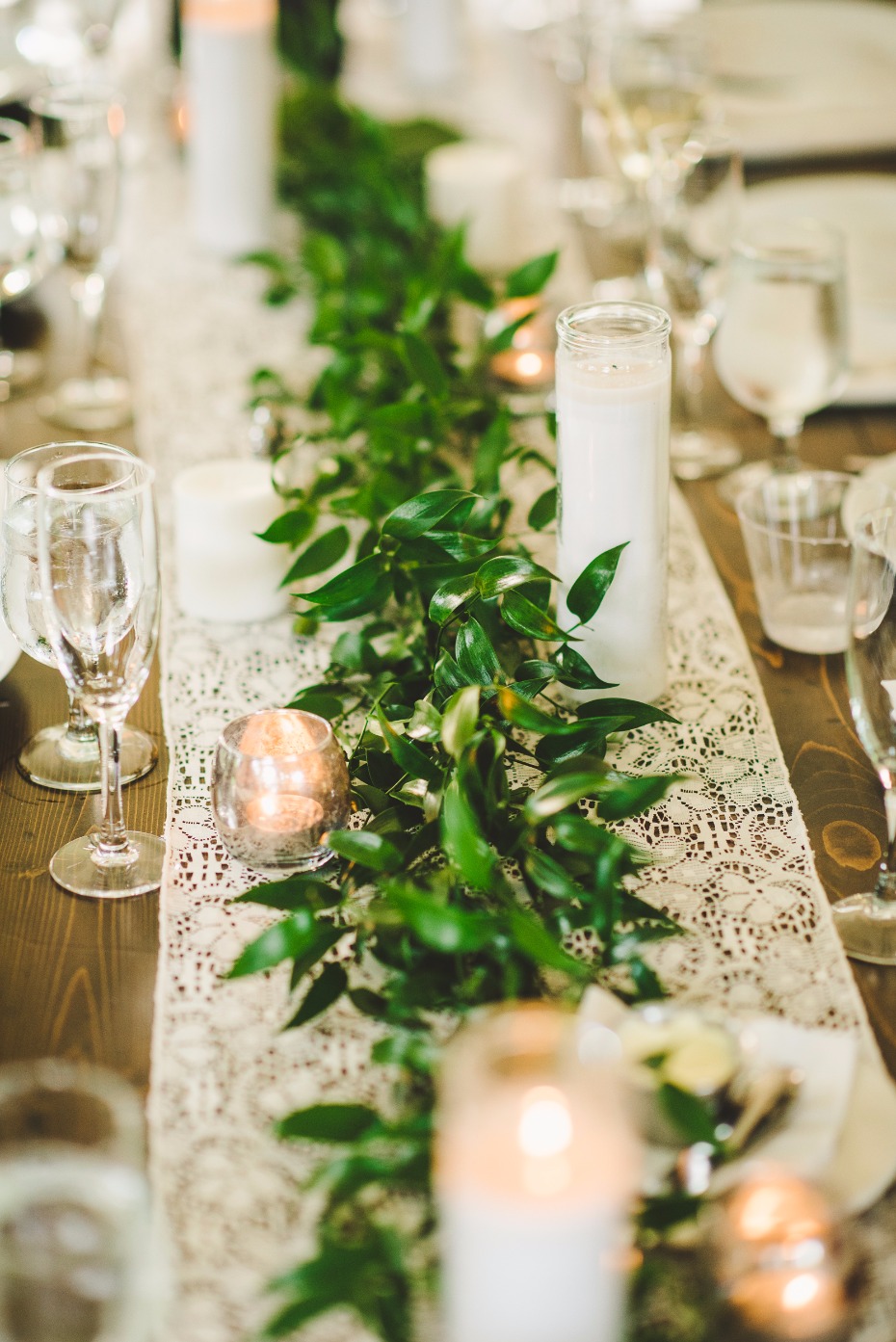 greenery garland on top of a lace table runner