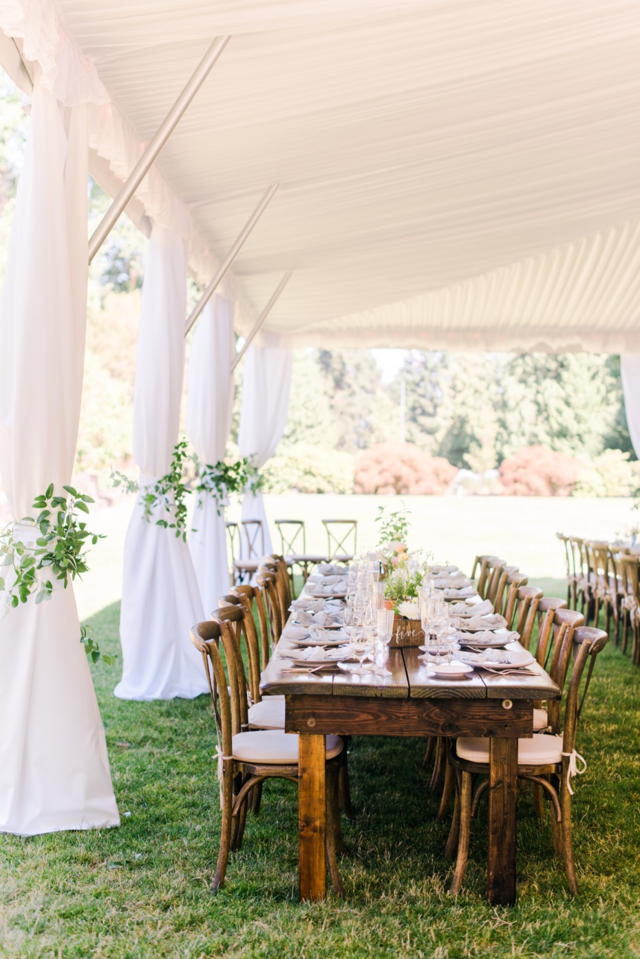 white tent wedding reception with family style seating