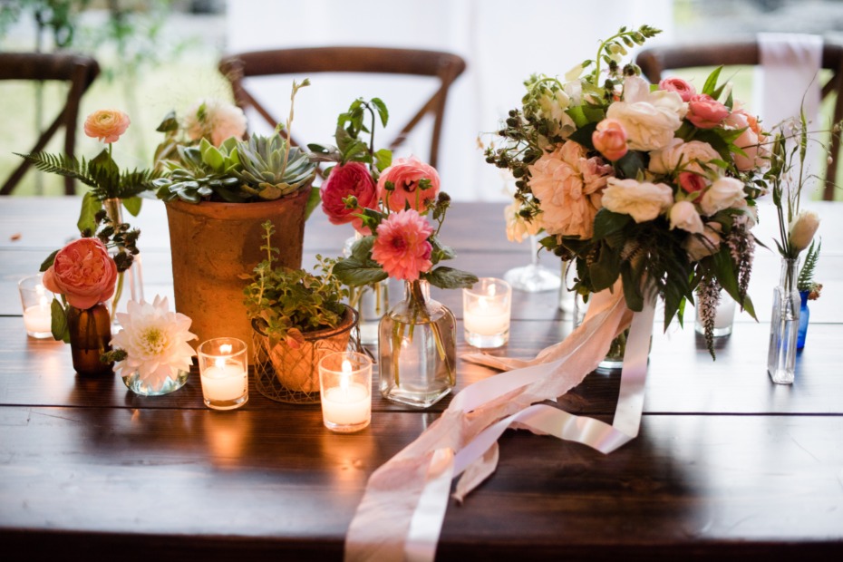 glowing wedding centerpieces with sweet bud vases and live potted plants