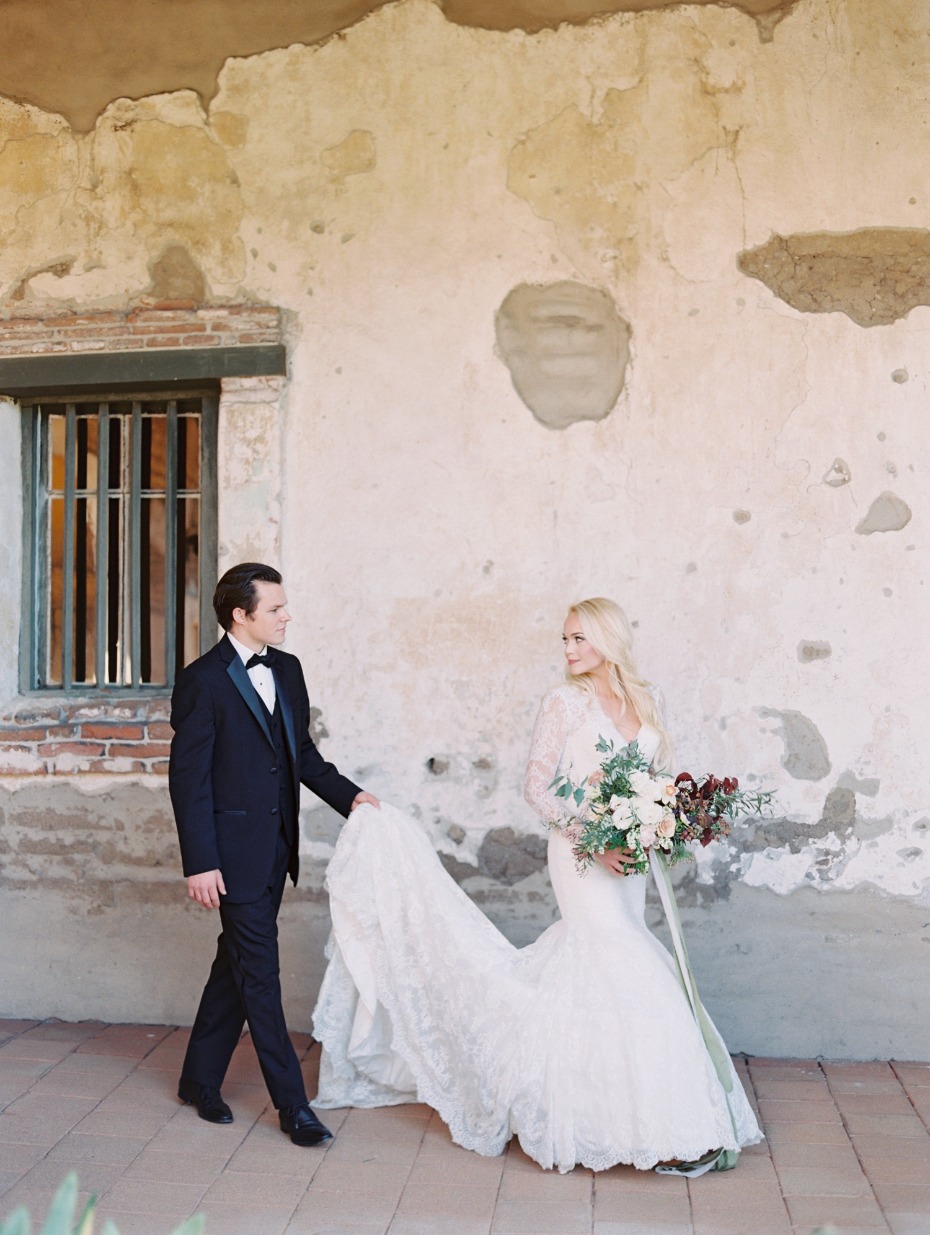 Elegant couple at a wedding location with old plaster walls