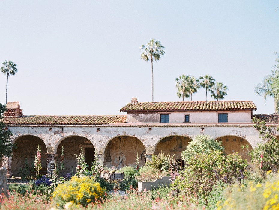 Mission garden with arched walkways and palm trees