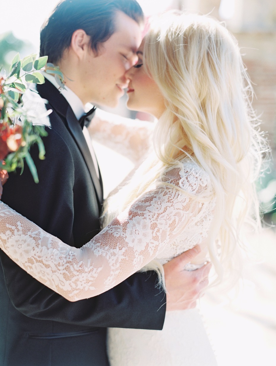 Bride and groom embrace lovingly on their wedding day