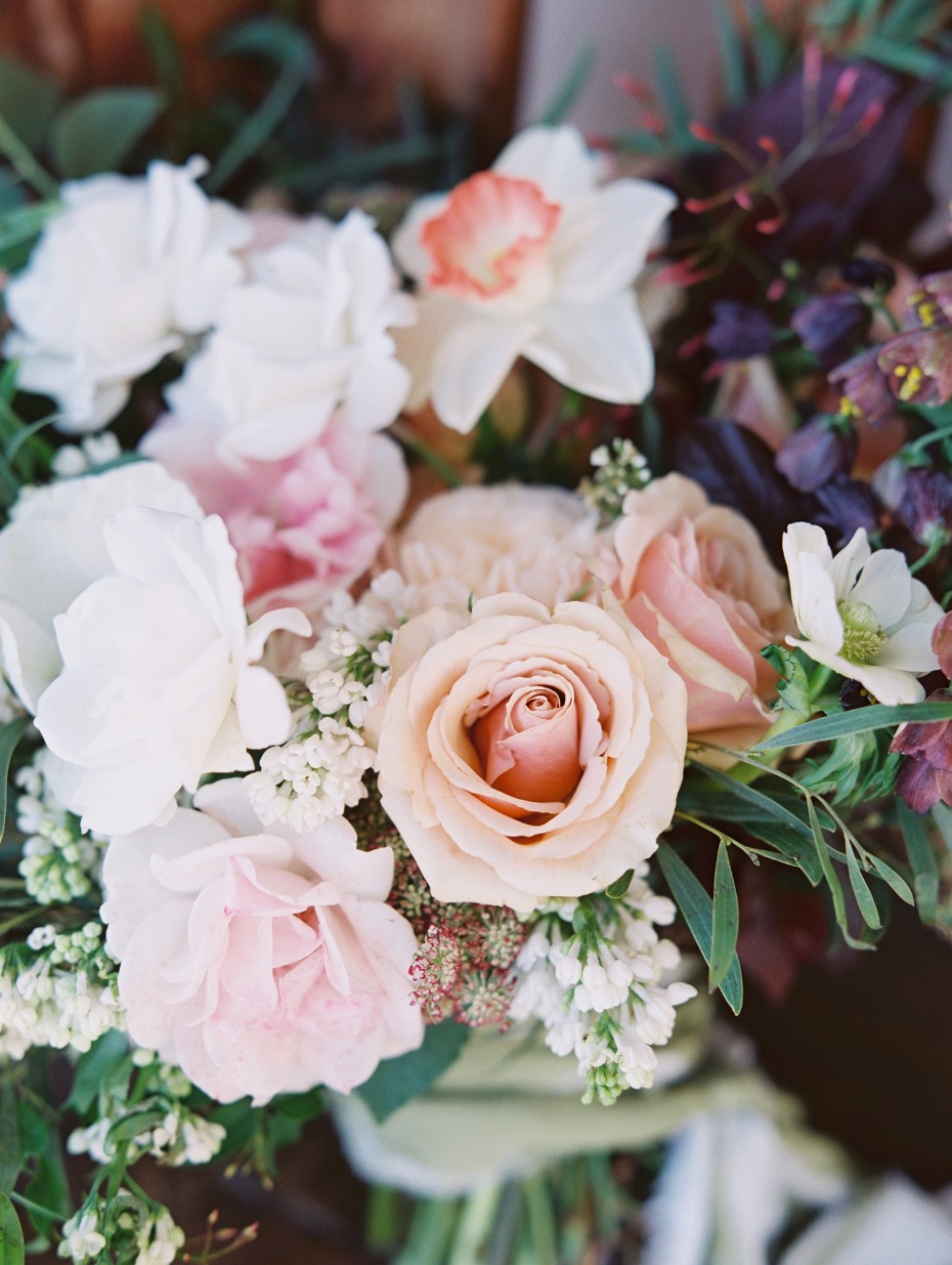 Elegant bouquet with roses and white flowers close up