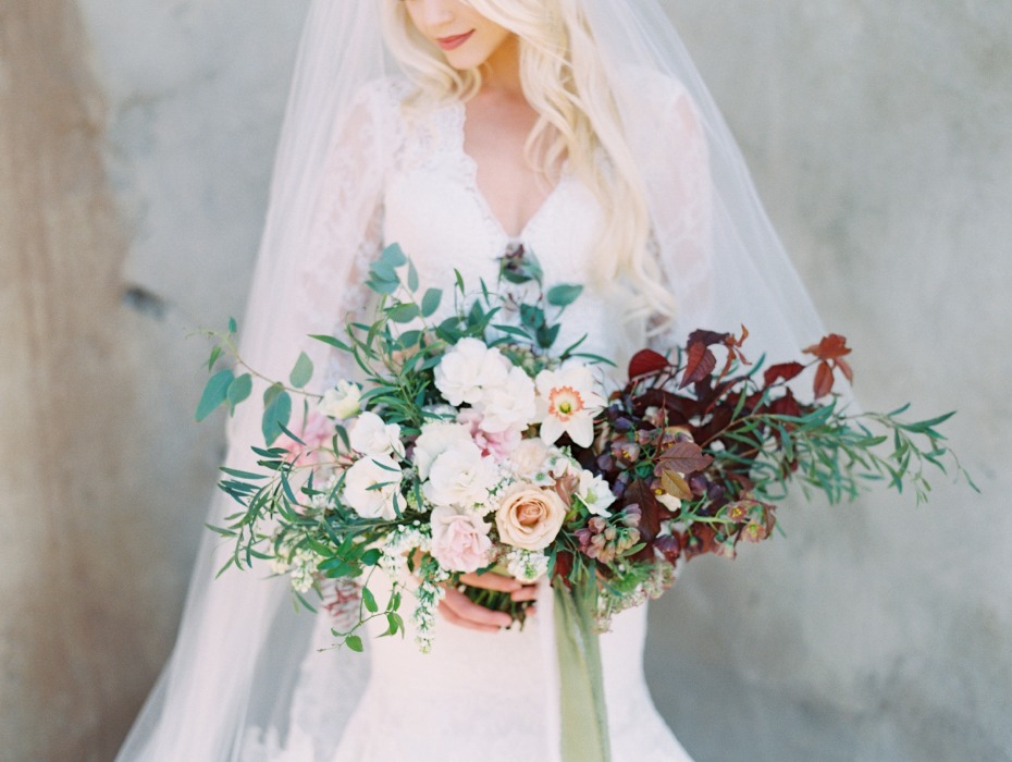 Bride holding a lush wedding bouquet of white flowers