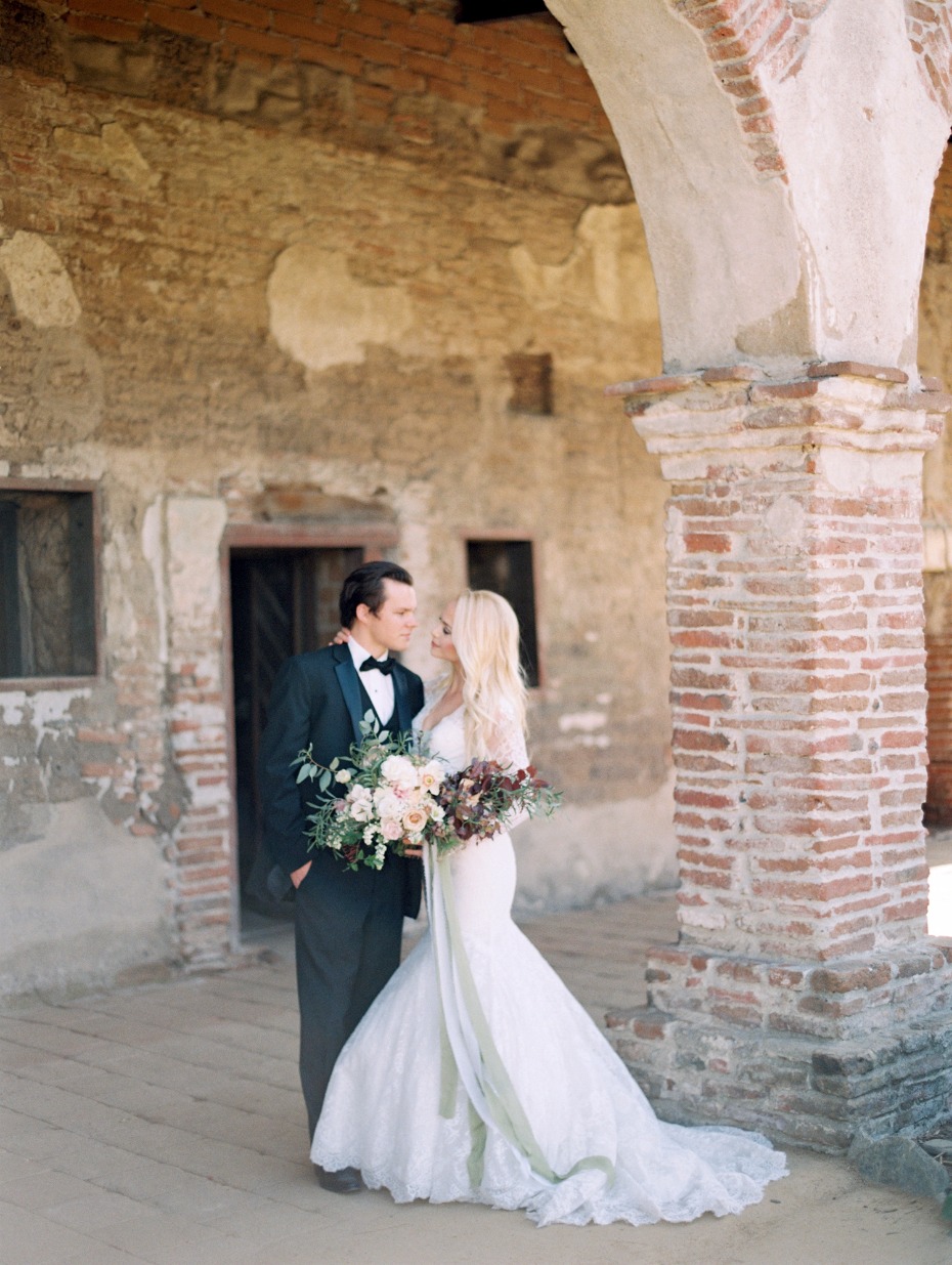 Elegant wedding couple at a historic mission location