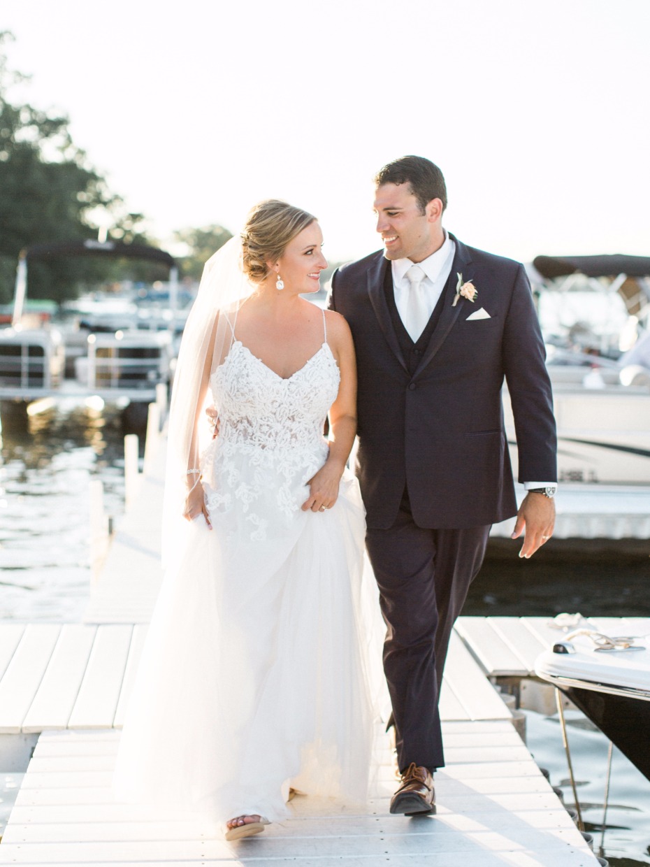 bride and groom on the dock at their beach house wedding