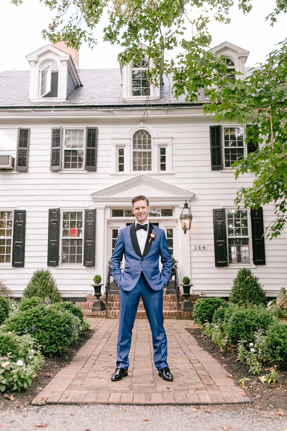 Groom in royal blue suite outside the Inn at Fernbrook Farms