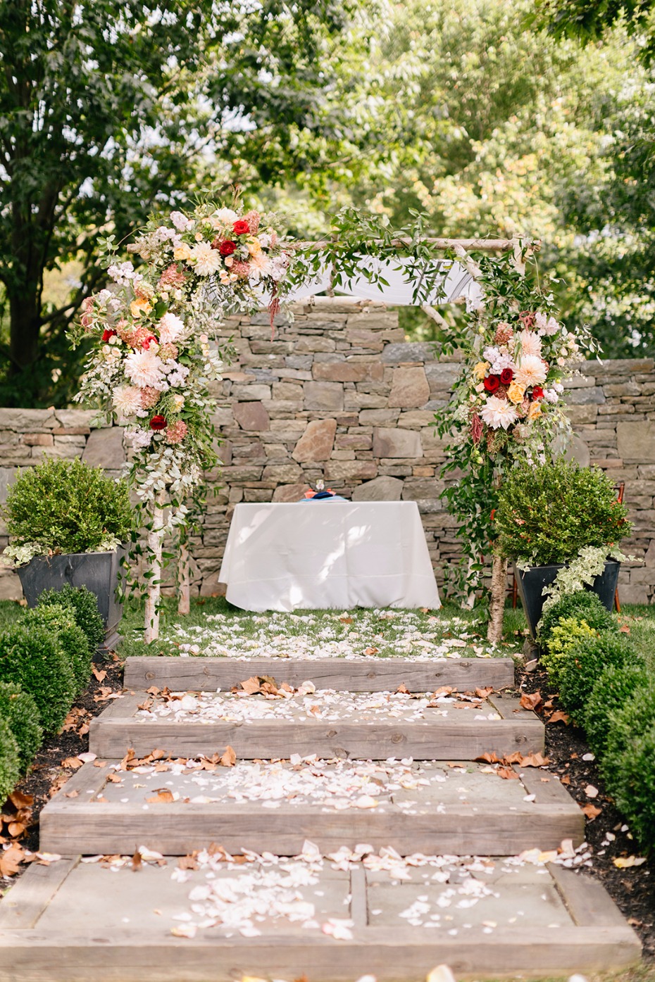 wedding chuppah accented by beautiful fall colored florals