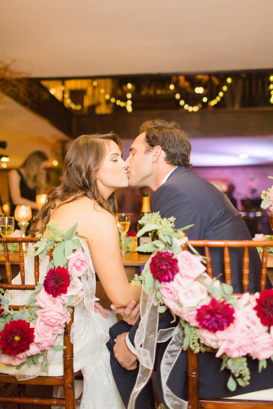 wedding kiss from the newlyweds at their sweetheart table