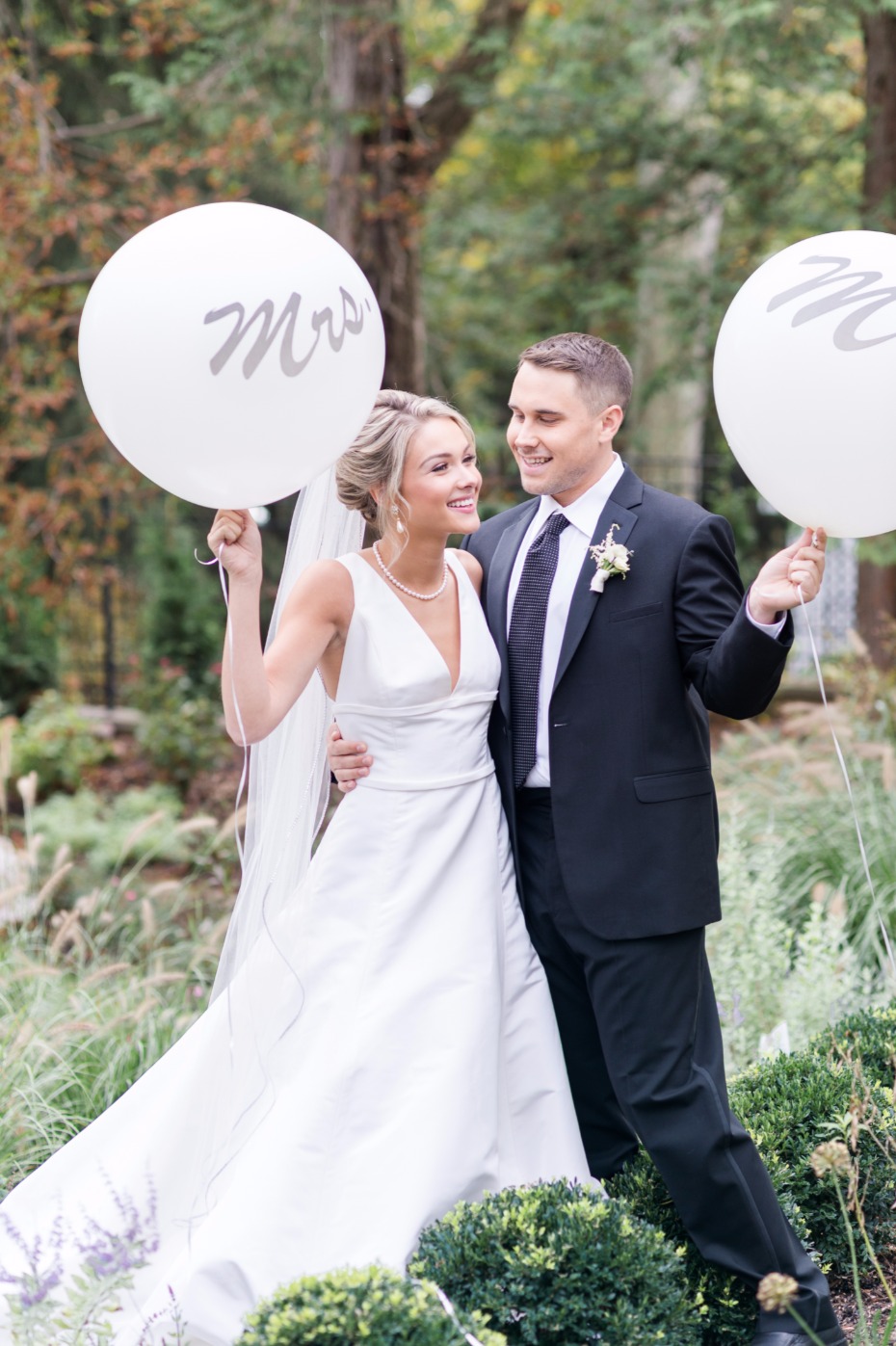 very cute bride and groom photo with mr and mrs giant balloons