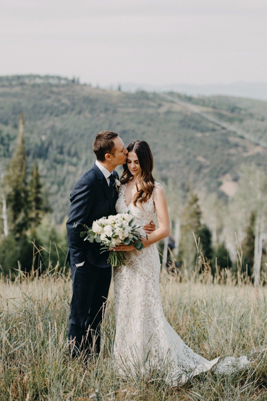 bride and groom on a mountain top in Utah