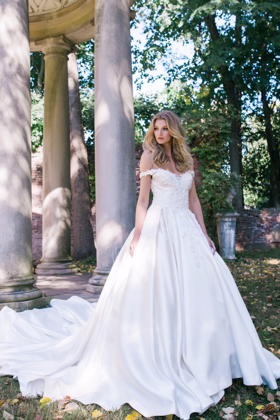 ivory floor length pleated bridal ballgown with a long train features embroidered off the shoulder bodice with sweetheart neckline.