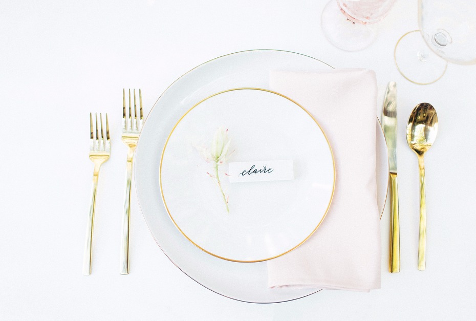 Gold rimmed plates and flatware