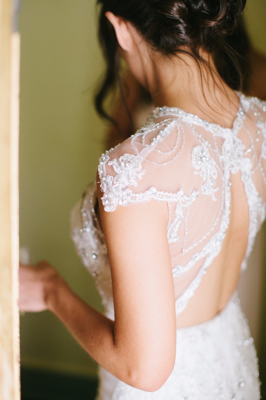 Bride wearing detailed beaded open back wedding dress