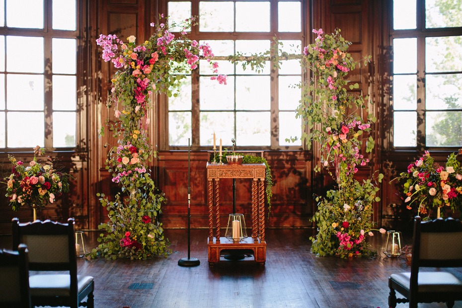 Romantic wedding ceremony decor with lush flower arch