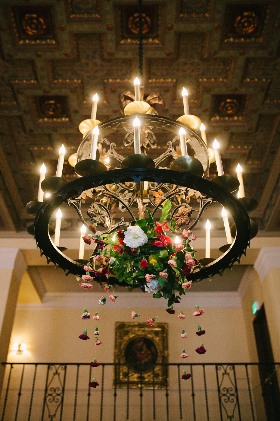 Floral chandelier with candles and decorative ceiling