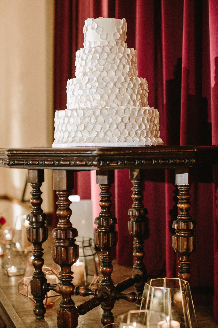 Elegant white wedding cake on a beautiful antique table