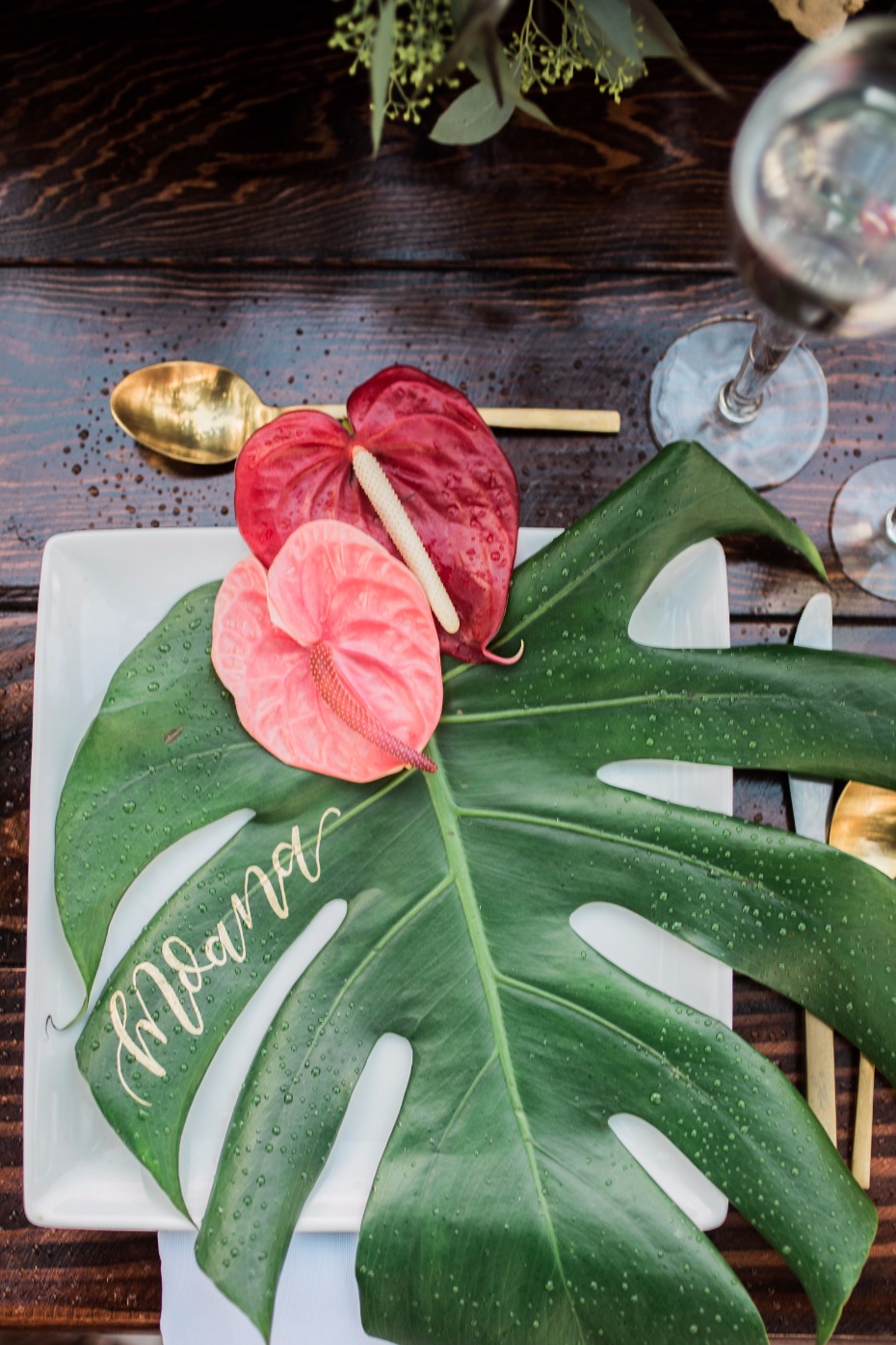Moana wedding place cards made out of giant tropical leaf