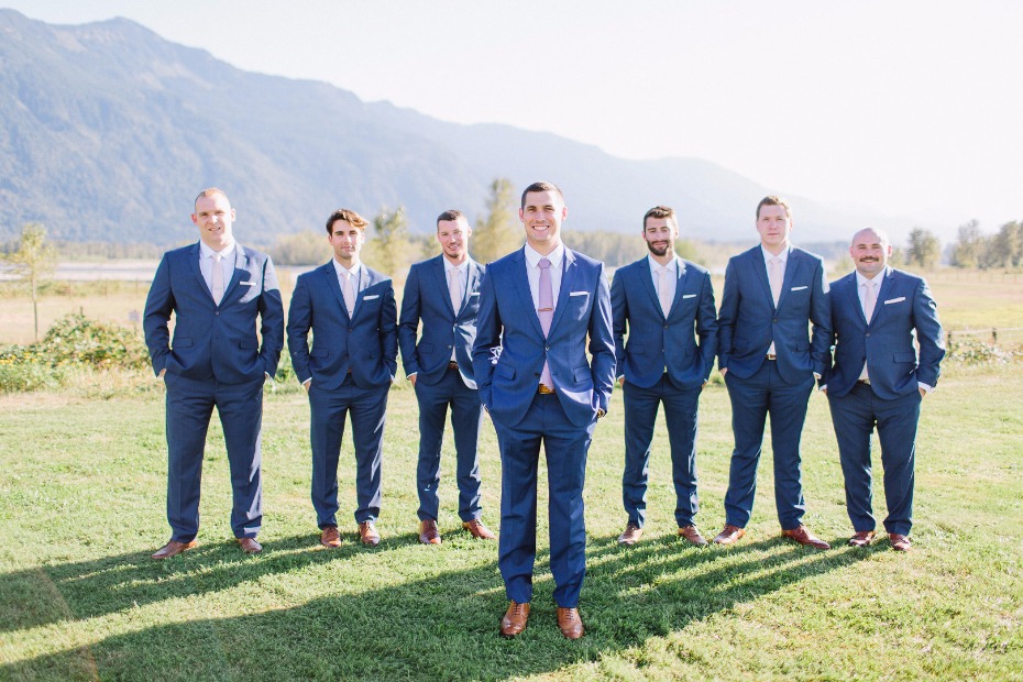 Groom in navy suits with blush ties