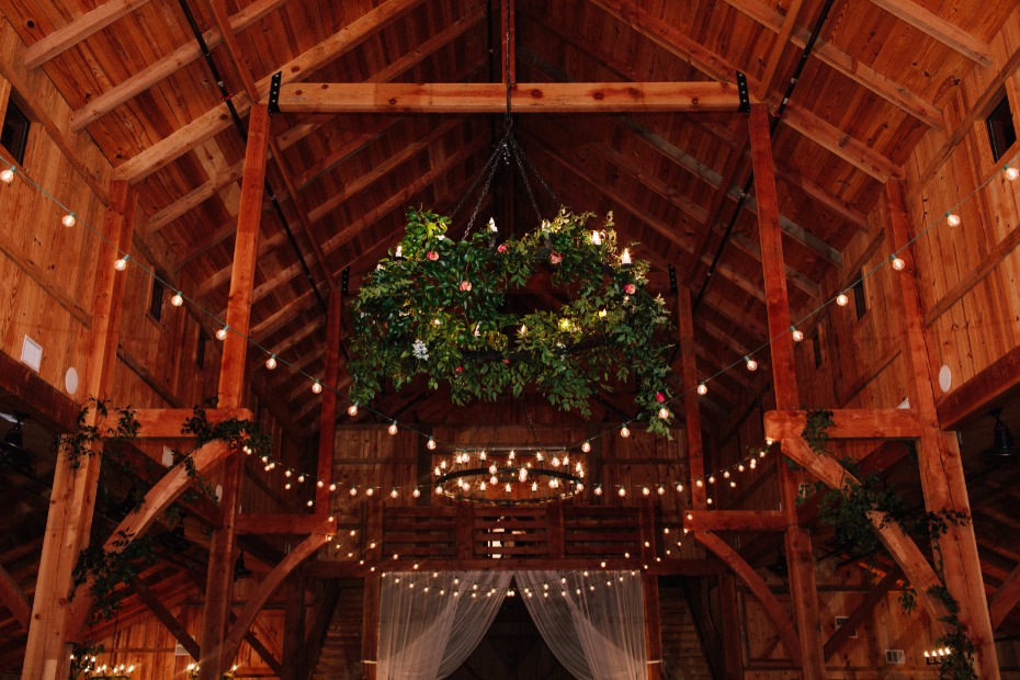 impressive floral accented chandelier at this rustic barn venue