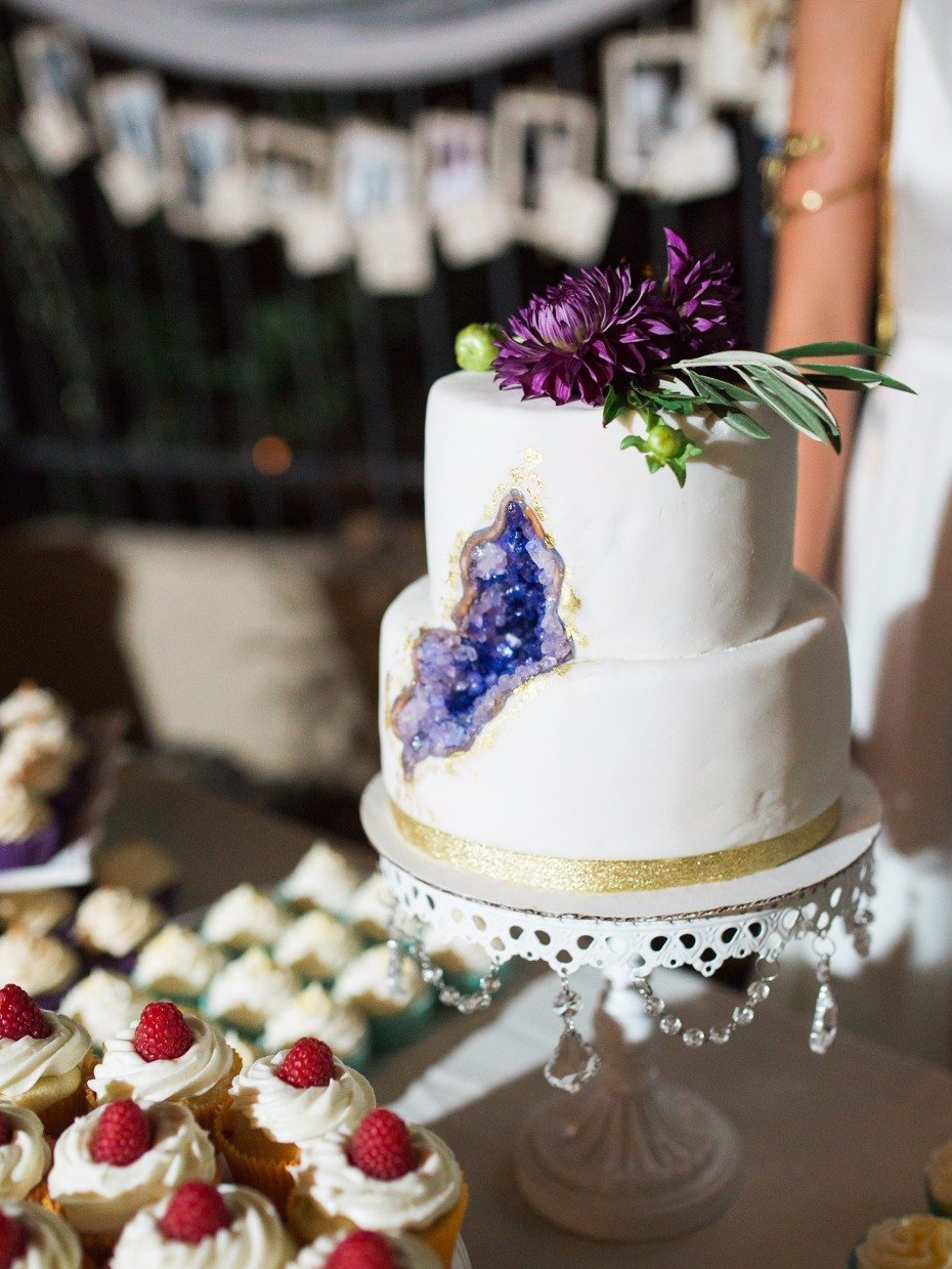 geode wedding cake with purple floral topper
