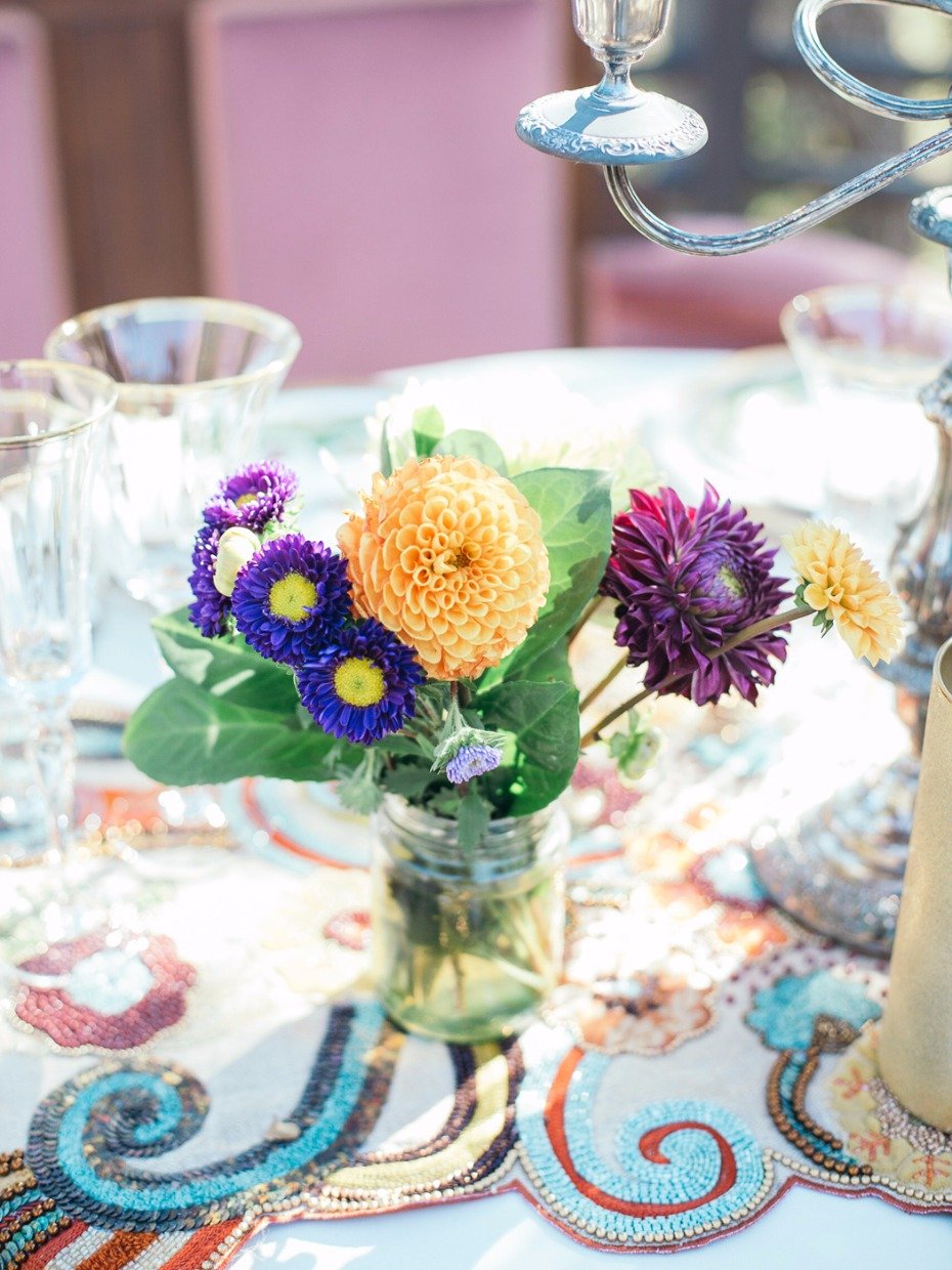 bright and fun wedding flowers in a mason jar for your sweetheart table