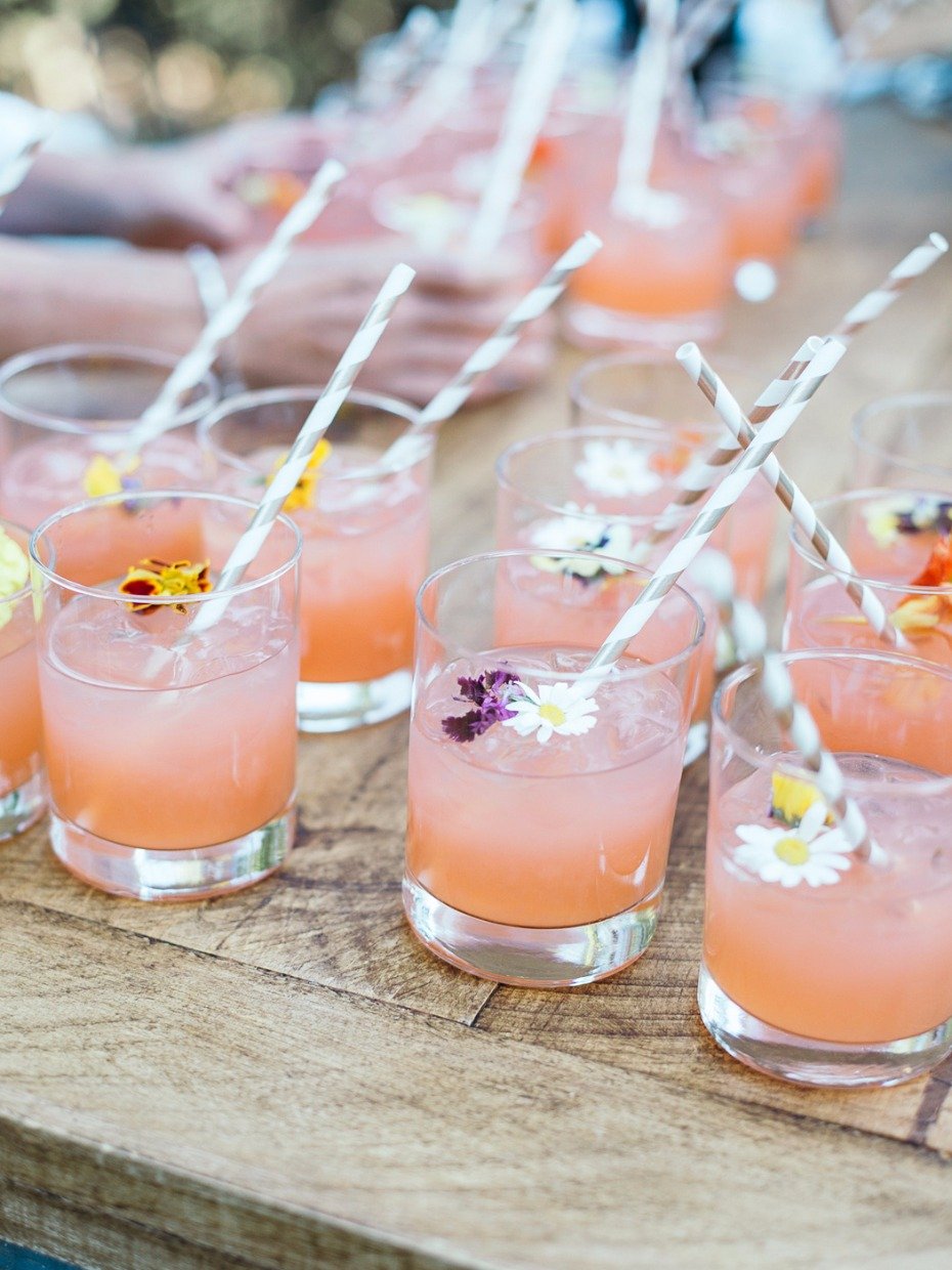 pink wedding cocktails with edible floral garnish
