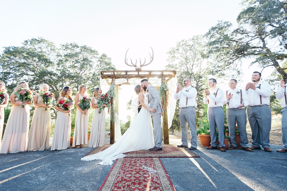 golden light back lit wedding kiss photo