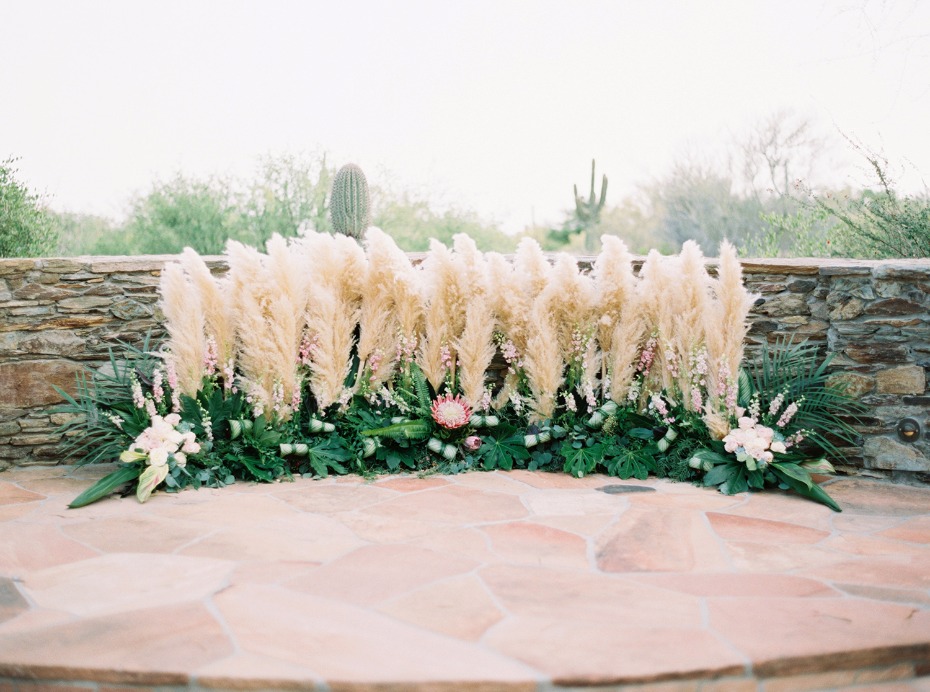desert grasses and tropical floral wedding backdrop