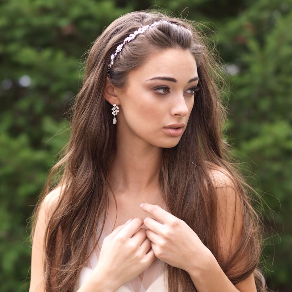 Woman with long hair wearing a bridal headband and earrings
