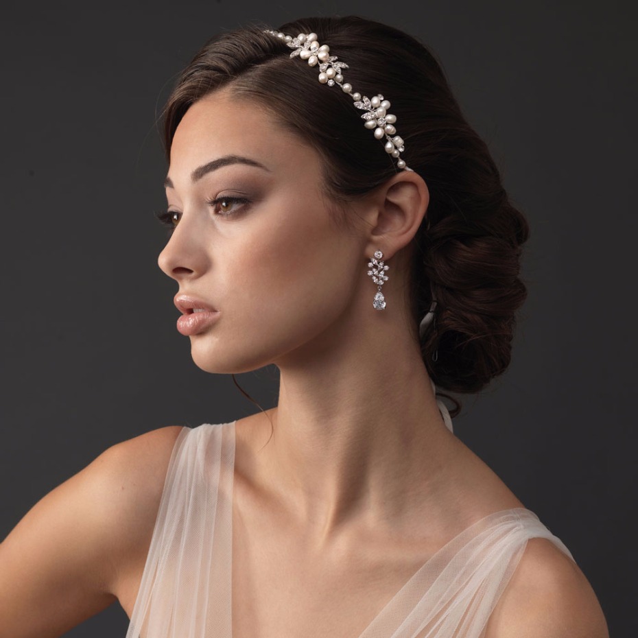 Woman wearing pearl and crystal bridal headpiece earrings