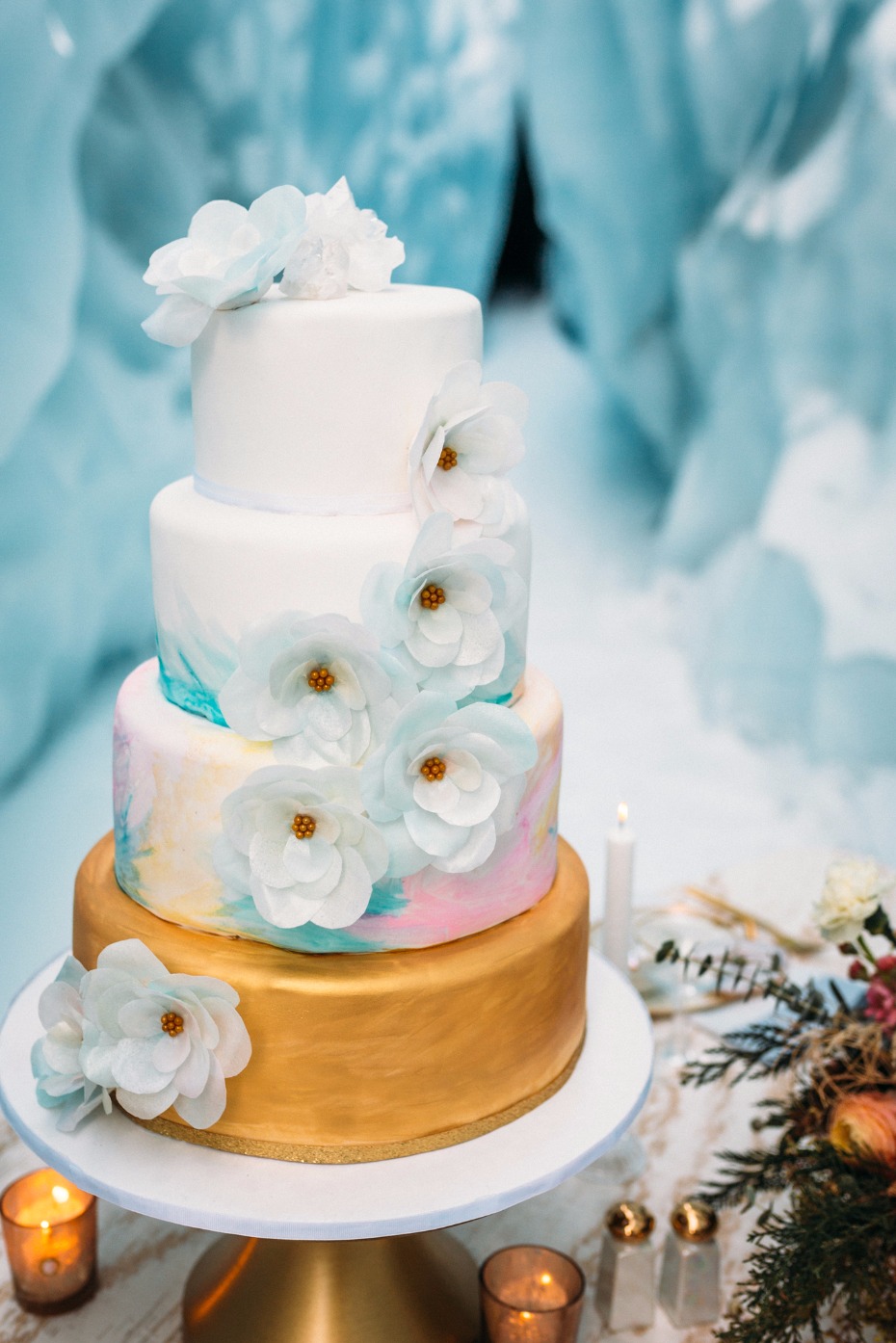 gold blue and pink wedding cake with sugar flower accents