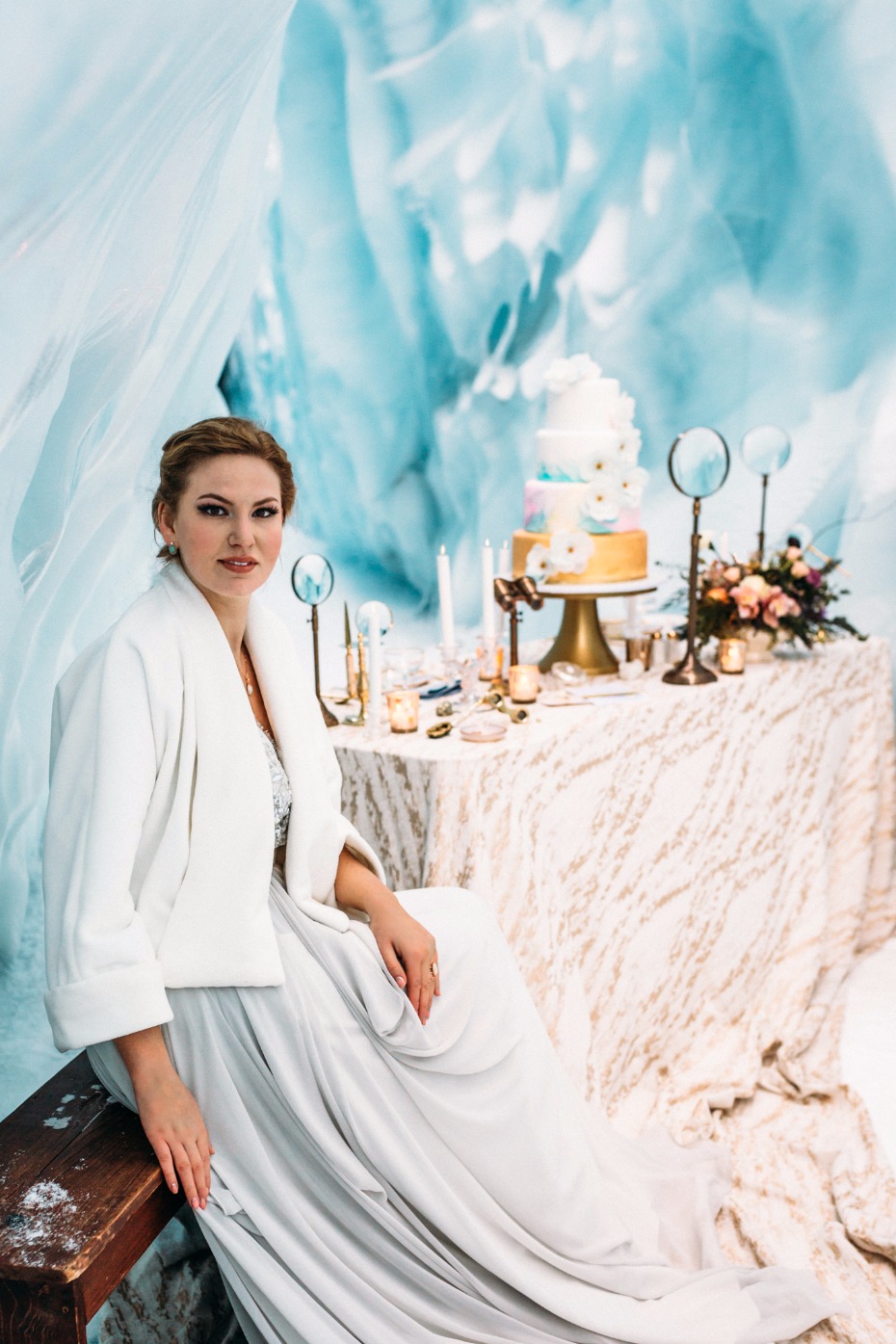 ice cave wedding ideas cake table with gold and blue accents