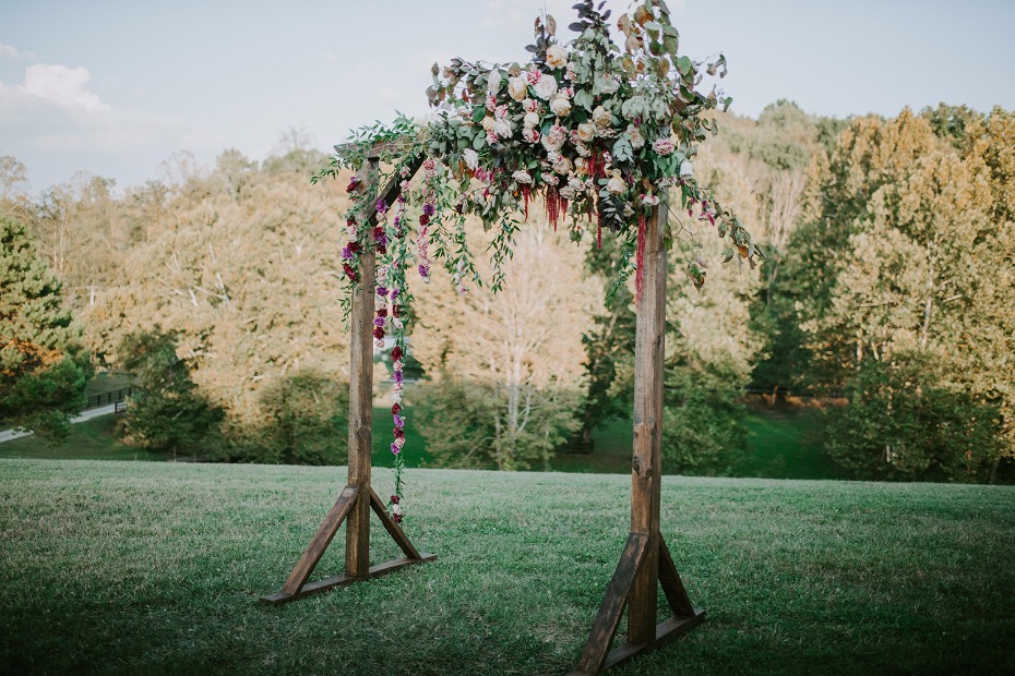 Wood ceremony arch covered in flowers