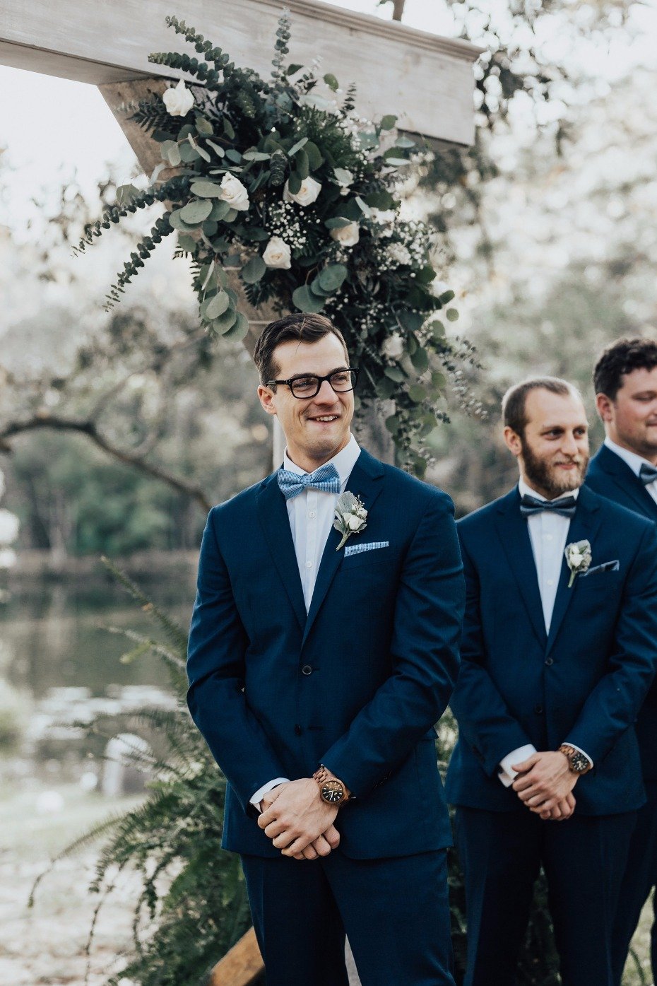 groom trying to hold it together after seeing his bride