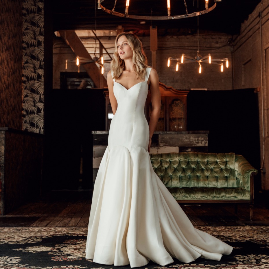 Bride in a white elegant wedding dress posing indoors