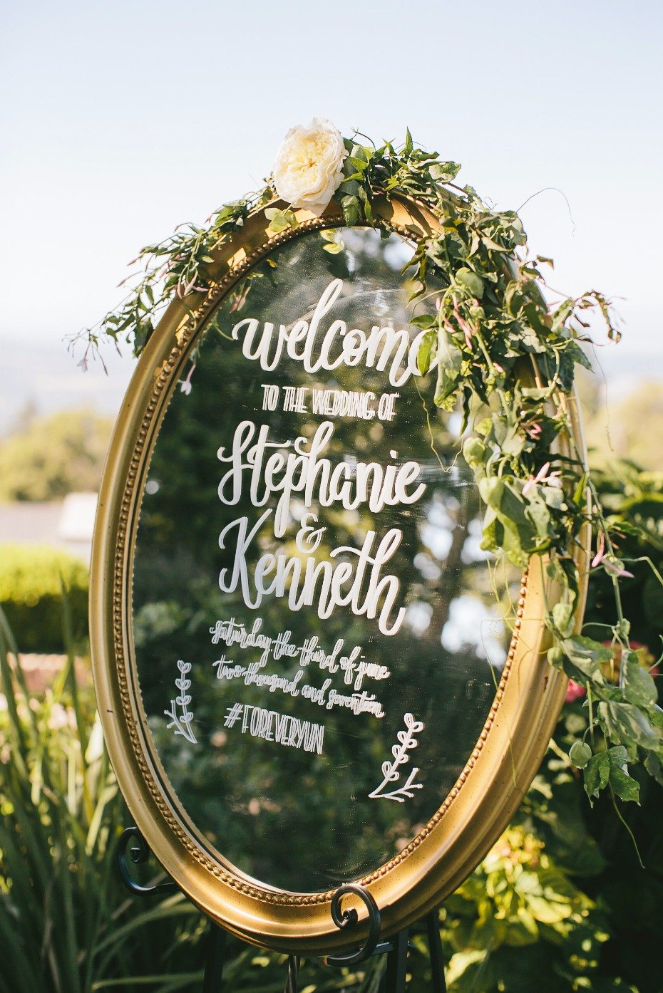 romantic mirror wedding sign with floral accents