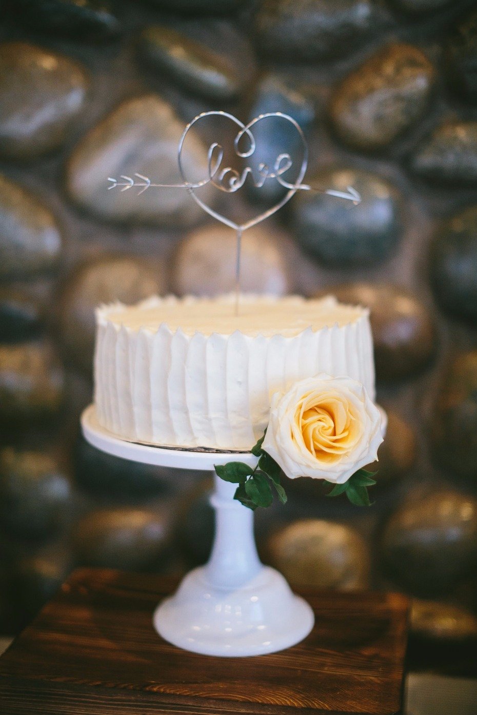 sweet and simple wedding cake with Love topper