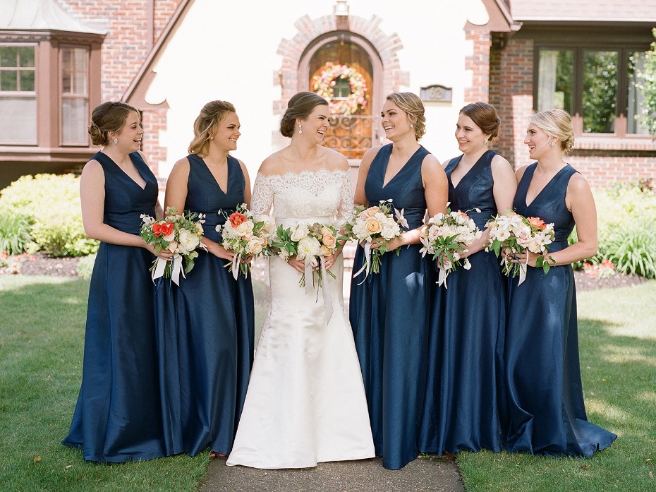 bridesmaids in floor length satin blue dresses