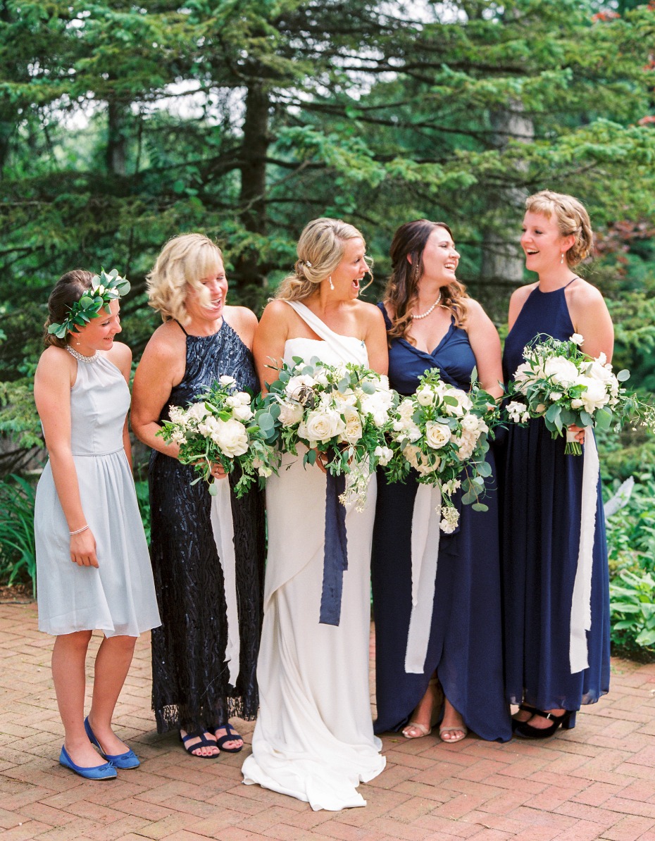bride and all her bridesmaids in varying blue dresses