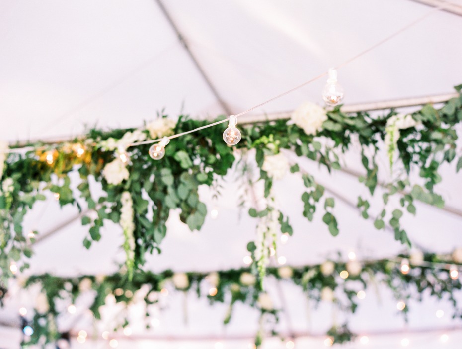 bistro lights and hanging eucalyptus brighten up the tent