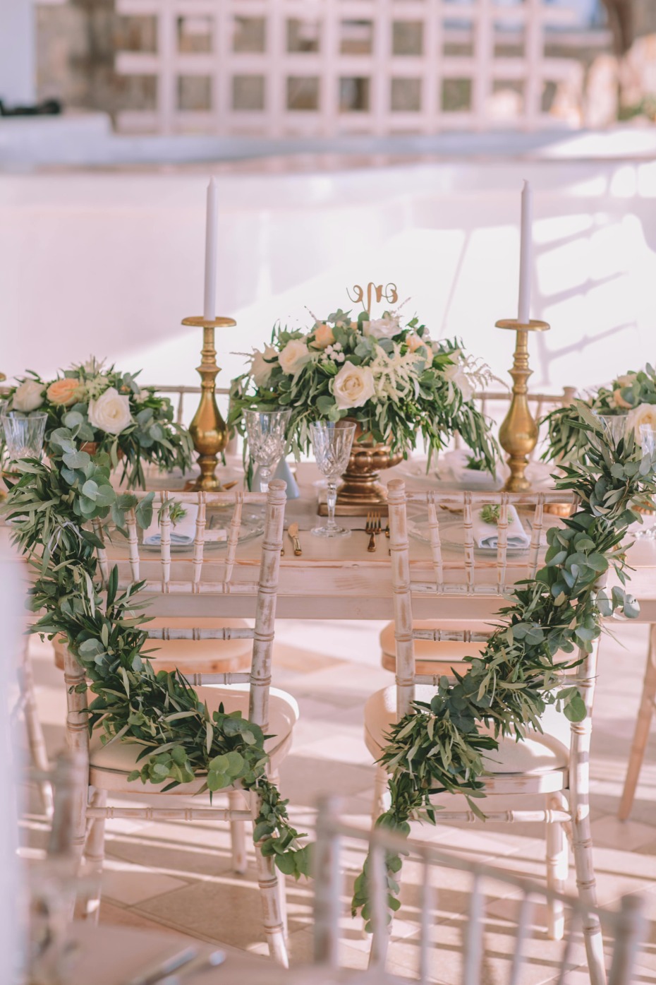 sweetheart table seats with greenery garlands