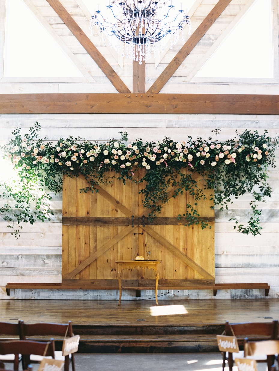 romantic cascading garden rose barn door ceremony backdrop